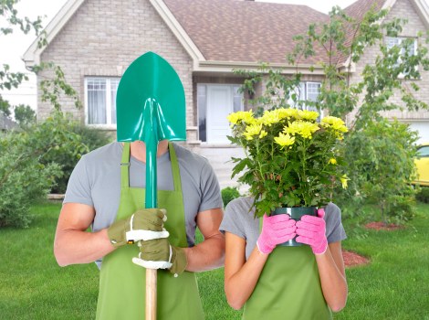 Trained gardener wearing PPE inspecting machinery