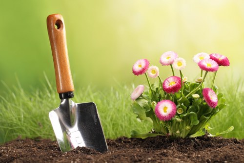 Gardener tending to flower beds in Feltham